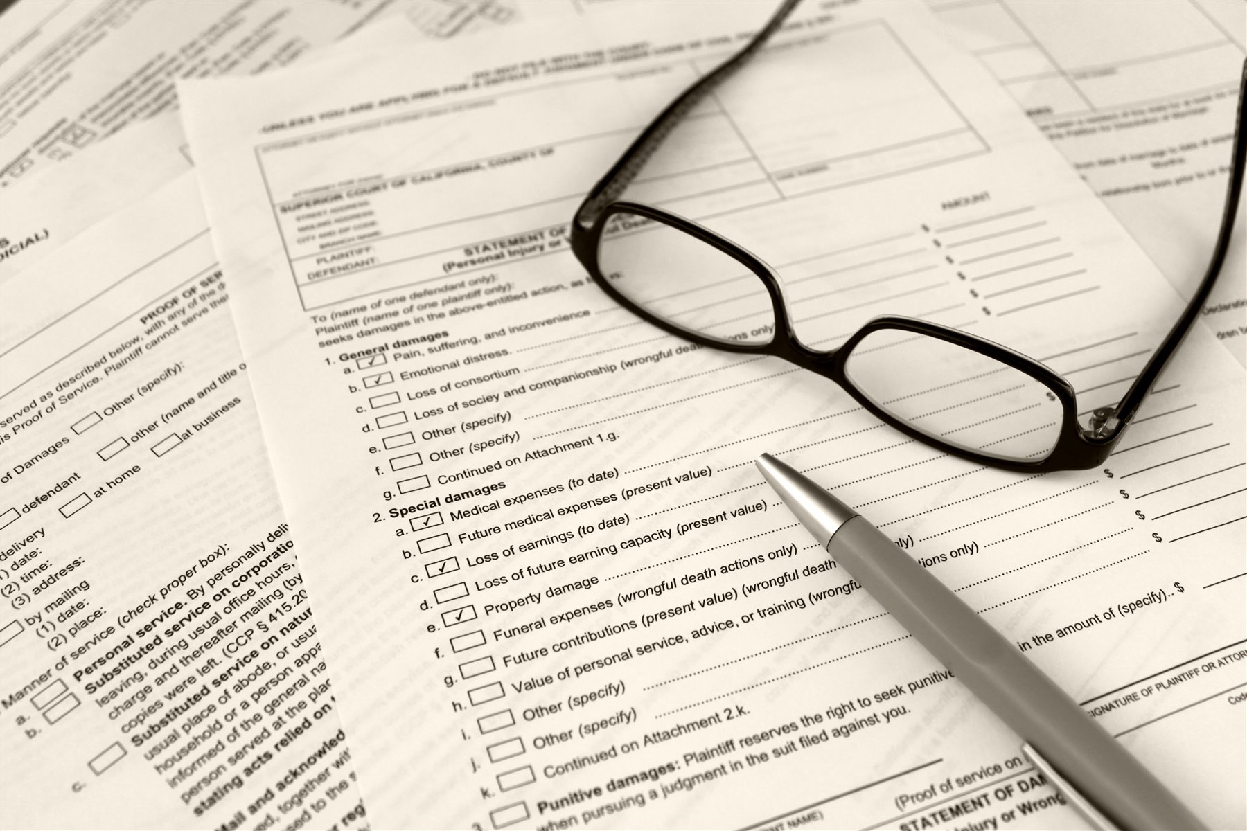 Documents, pen, and glasses prepared for detailed review